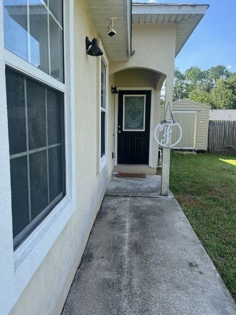 A house with a concrete walkway leading to the front door