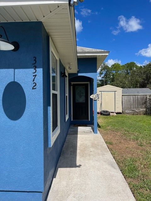 A blue house with the number 3672 on the side