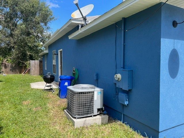 A blue house with a satellite dish on top of it