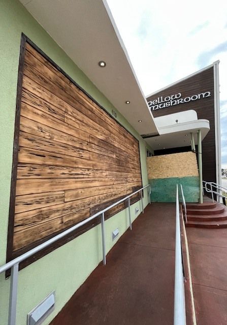 A building with a wooden wall and stairs leading up to it