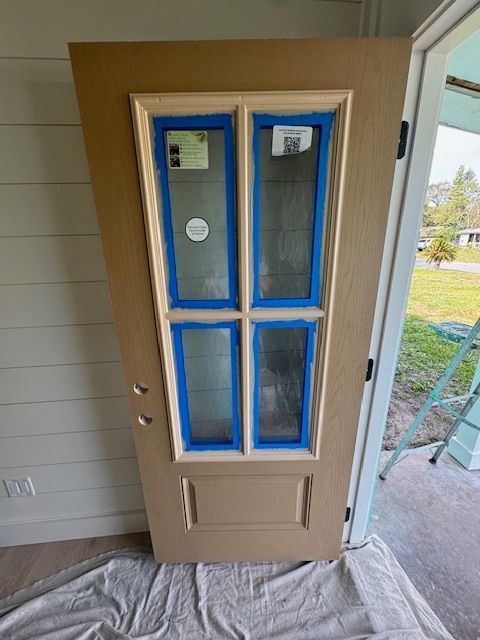 A door with blue tape on it is sitting on a table.