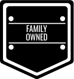 A black and white shield with the words `` family owned '' written on it.