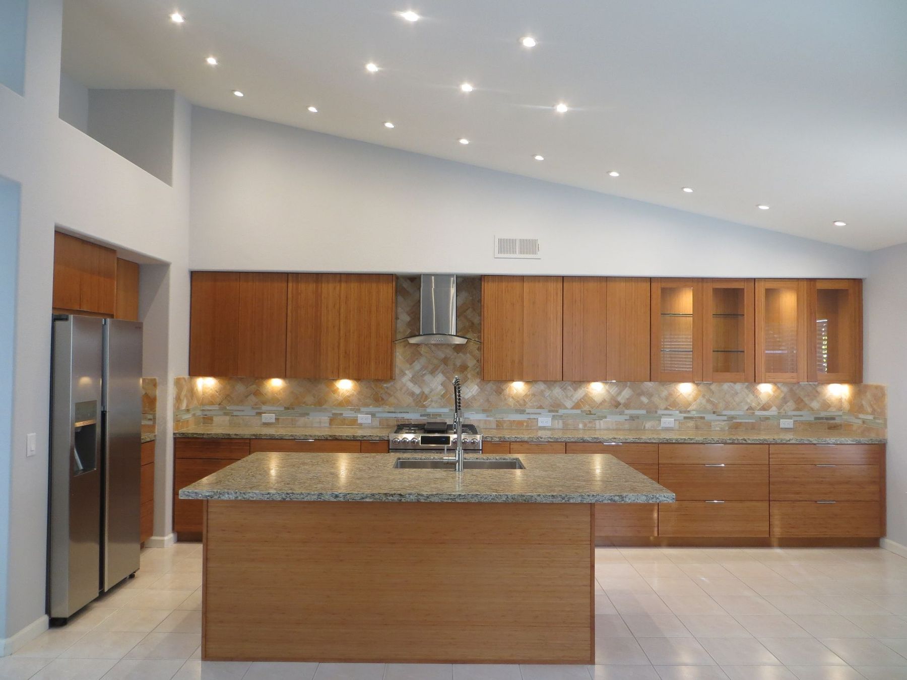 A kitchen with stainless steel appliances and wooden cabinets