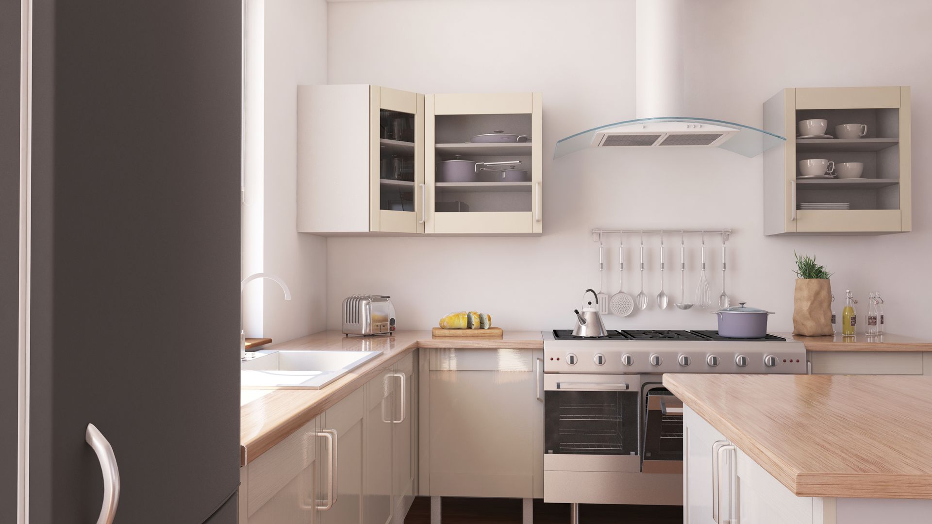 A small, bright kitchen with white cabinets, stainless steel appliances, and a wooden countertop.