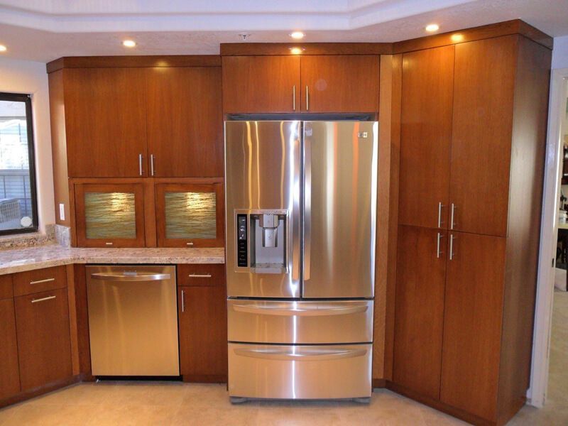 A kitchen with stainless steel appliances and wooden cabinets