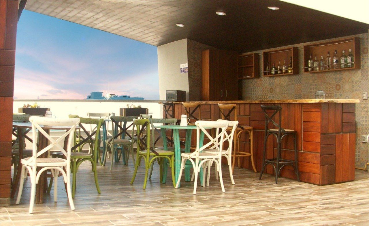 A restaurant with tables and chairs and a bar