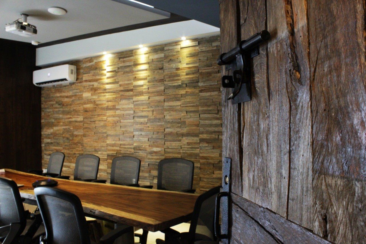 A conference room with a wooden table and chairs