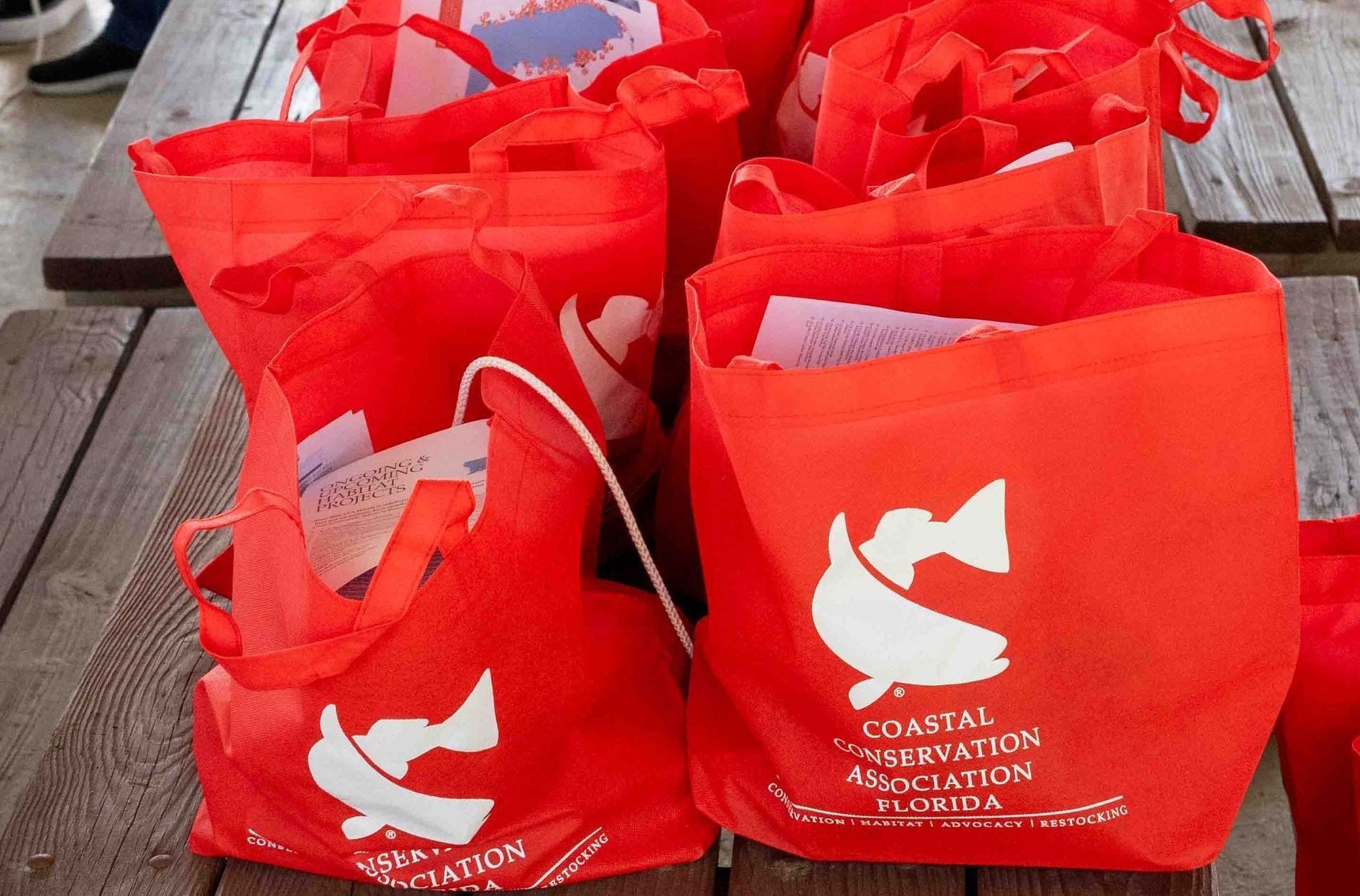 A group of red bags sitting on top of a wooden table.