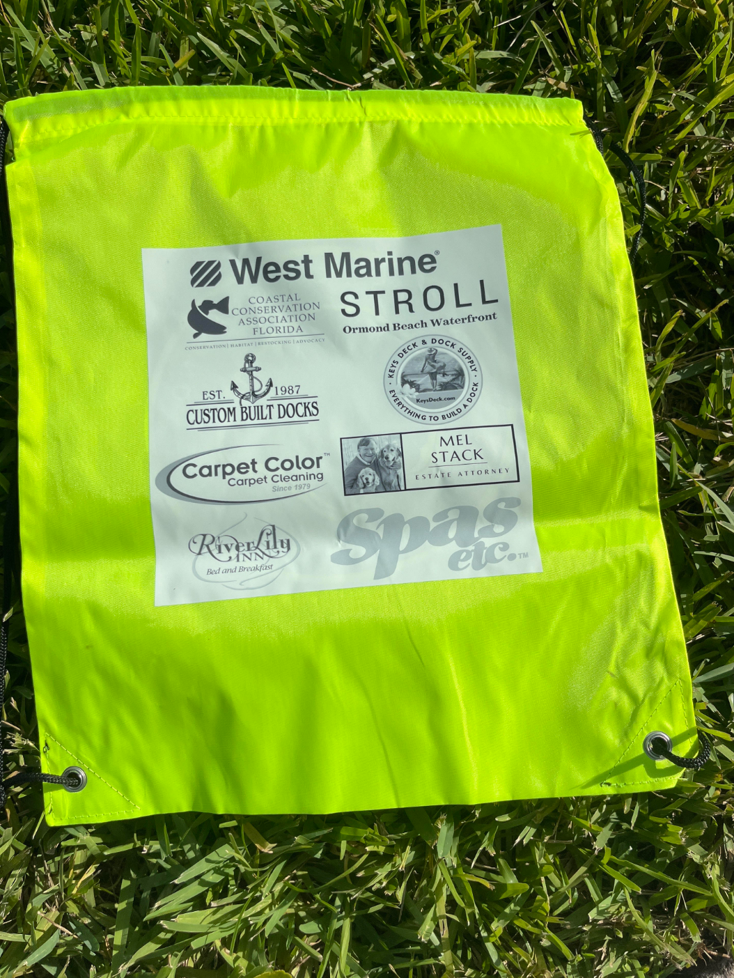 A yellow bag that says west marine stroll on it