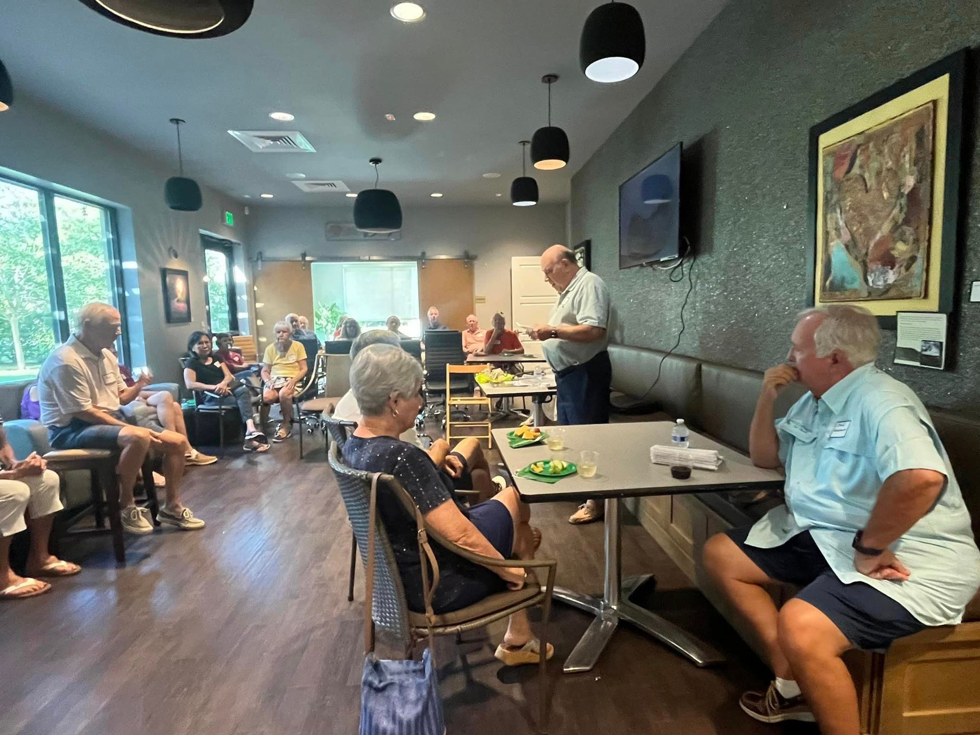 A group of people are sitting at tables in a room.
