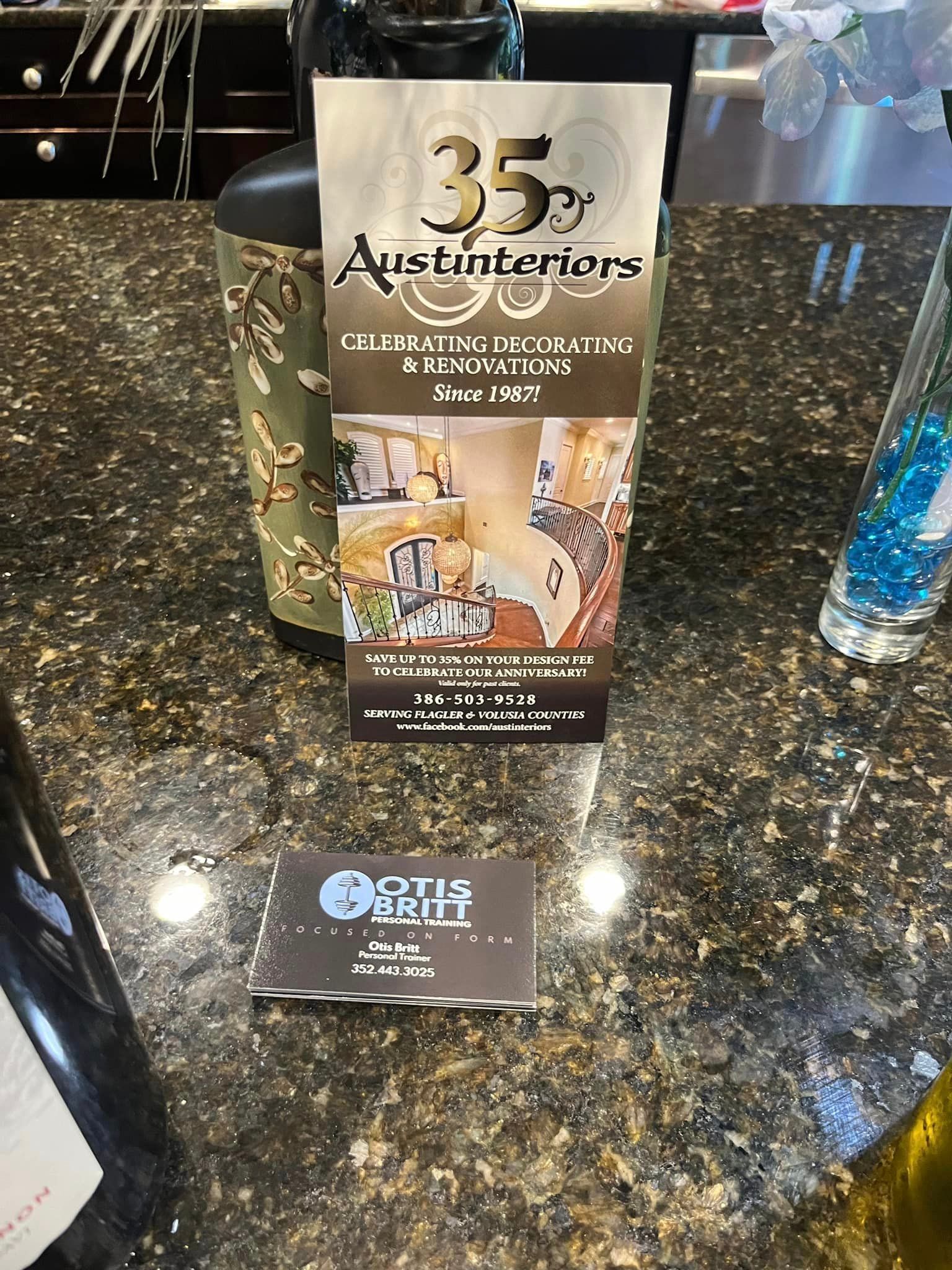 A card is sitting on a counter next to a bottle of wine.