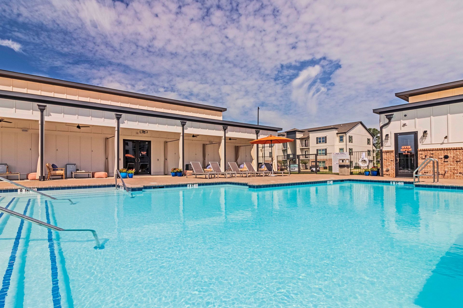 A large swimming pool in the middle of an apartment building at Pointe Grand Warner Robins.