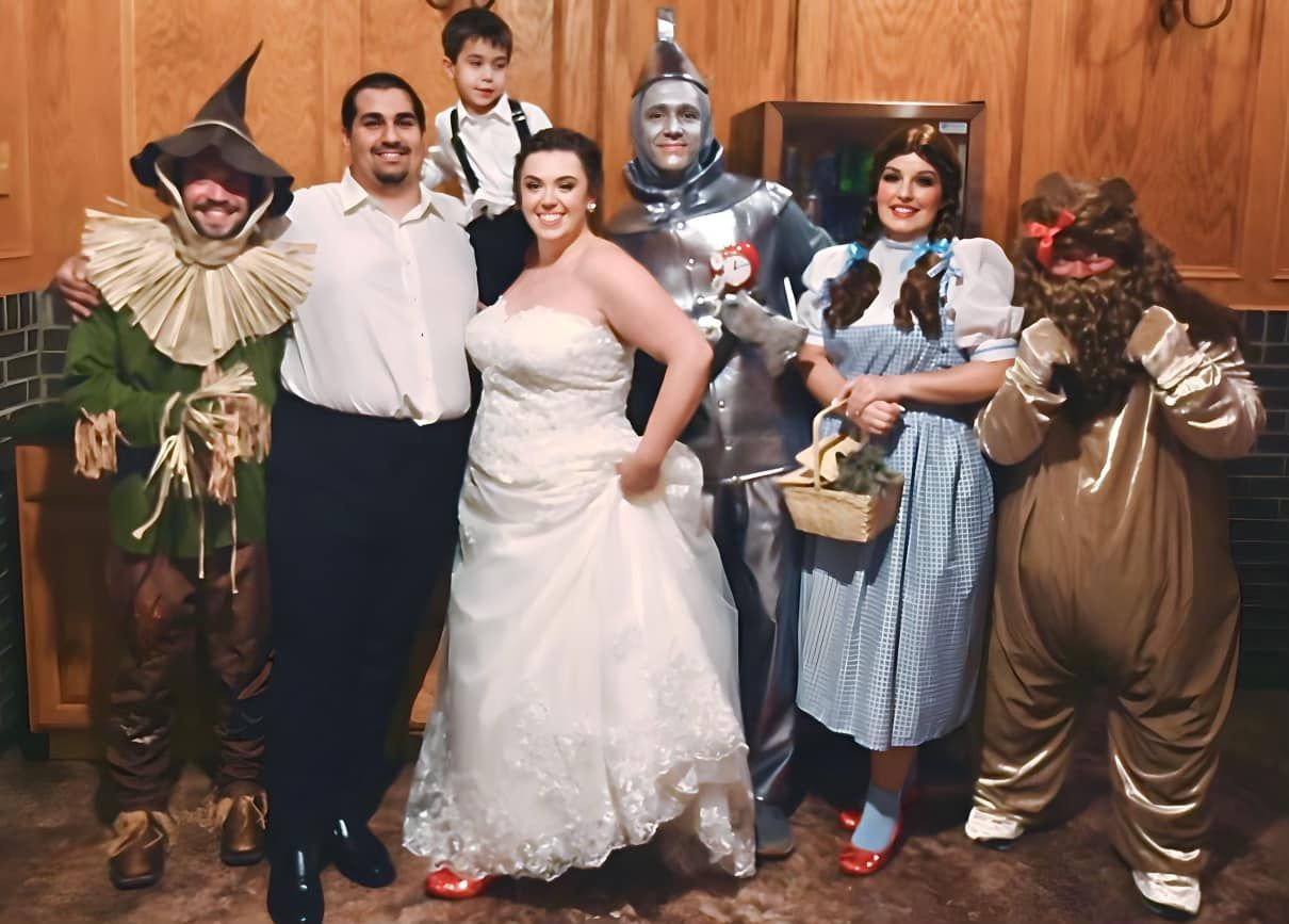 Wedding party posing in Wizard of Oz costumes.