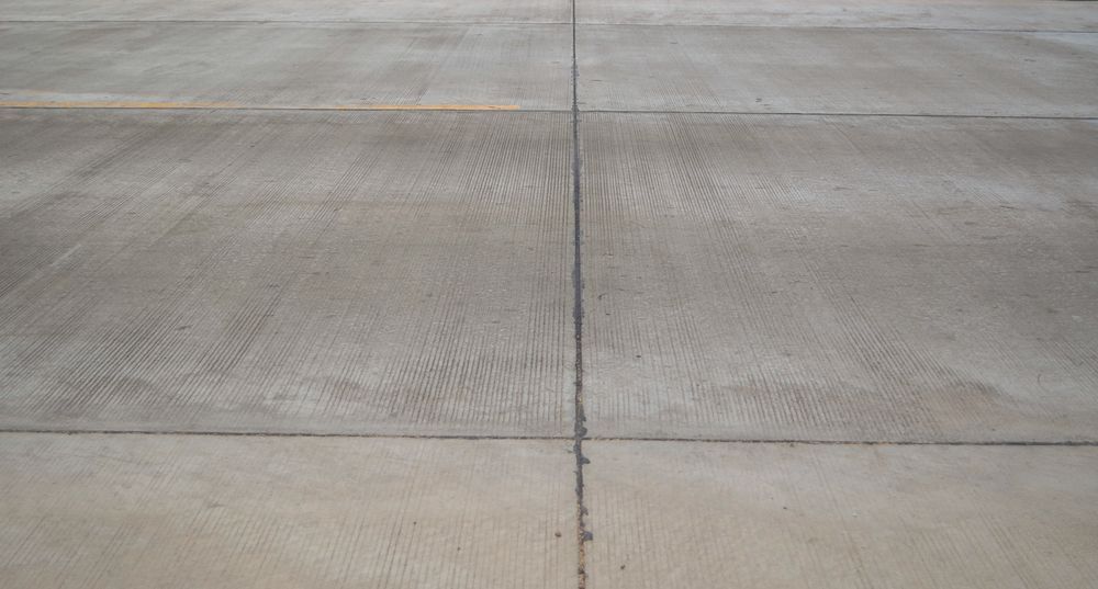 A Close Up Of A Concrete Floor With A Yellow Line On It — Pigot's Midwestern Mini Mix In Orange, NSW