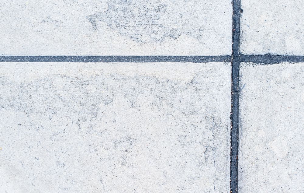 A Close Up Of A Tiled Floor With A Black Line Between The Tiles — Pigot's Midwestern Mini Mix In Orange, NSW