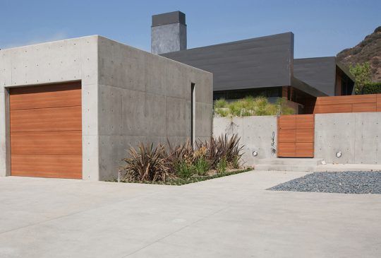 A Concrete Building With A Wooden Garage Door In Front Of A House — Pigot's Midwestern Mini Mix In Orange, NSW