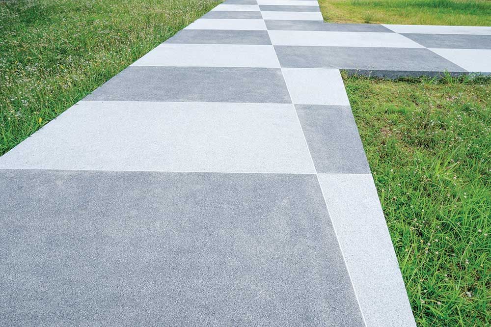 A Concrete Walkway With A Checkered Pattern Is Surrounded By Grass — Pigot's Midwestern Mini Mix In Orange, NSW