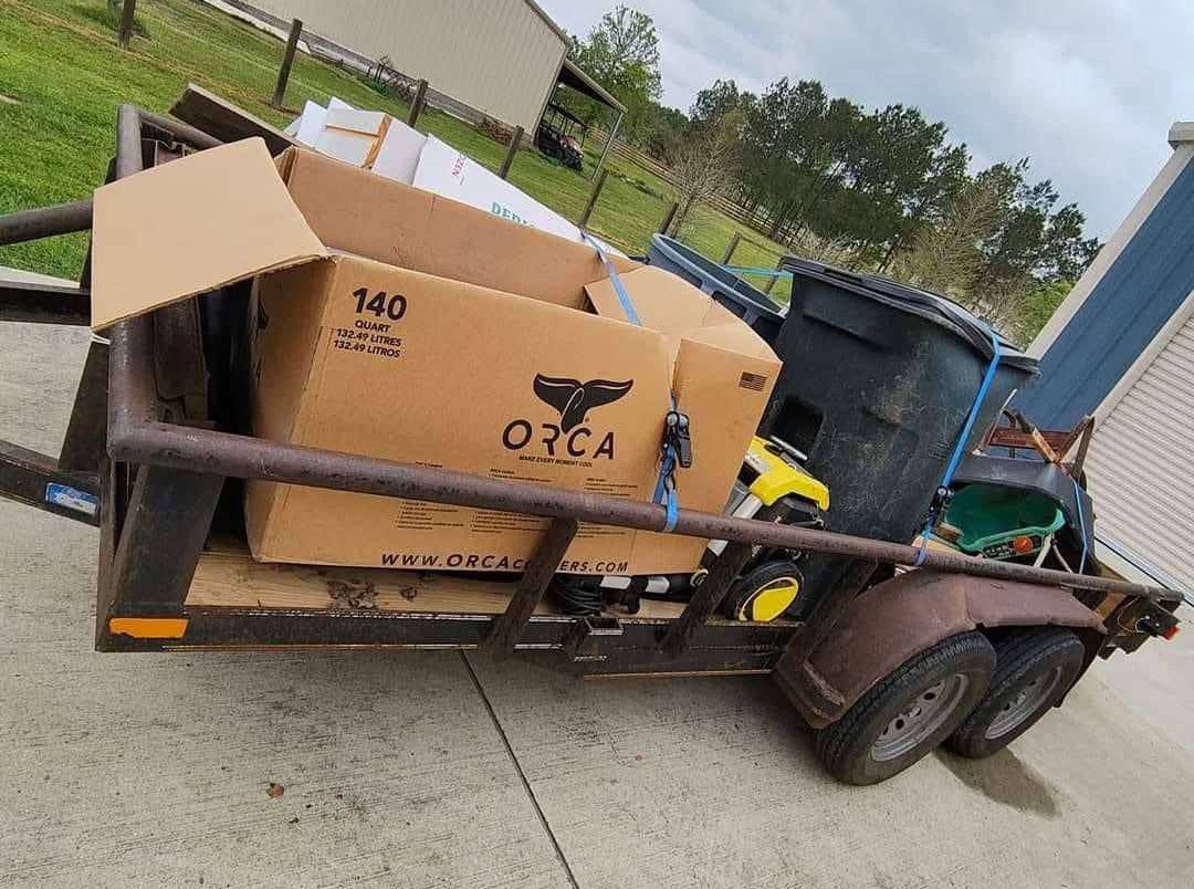 A cardboard box is sitting on top of a trailer.