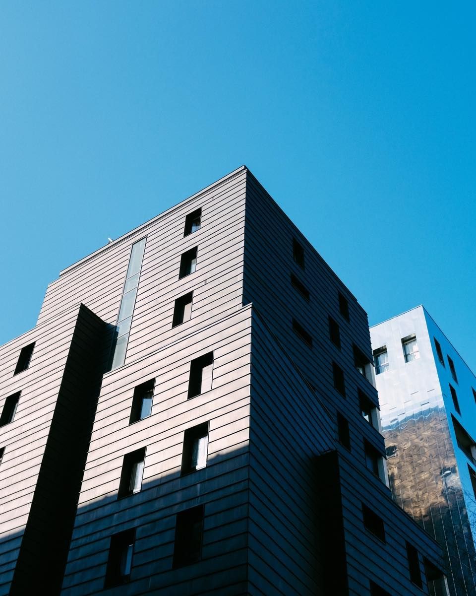 Looking up at a tall building with a blue sky in the background