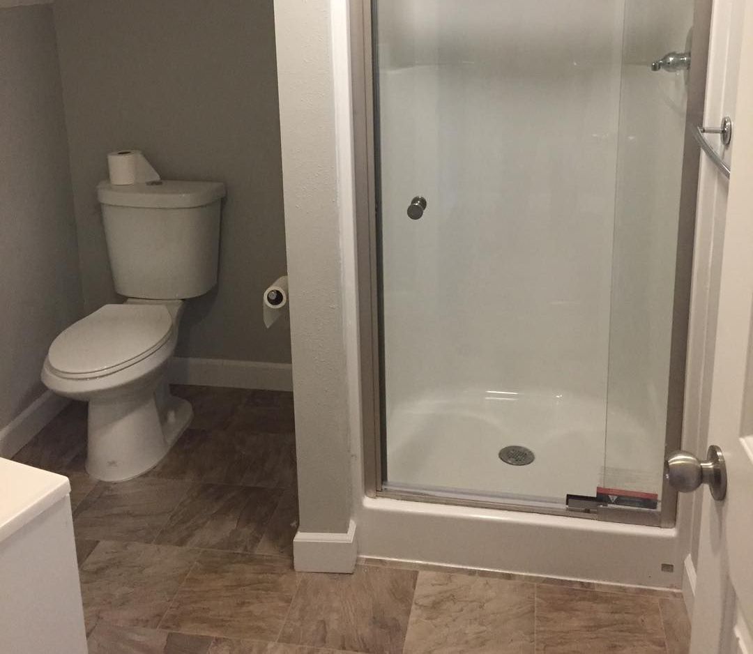 There is a toilet and a shower in the bathroom.