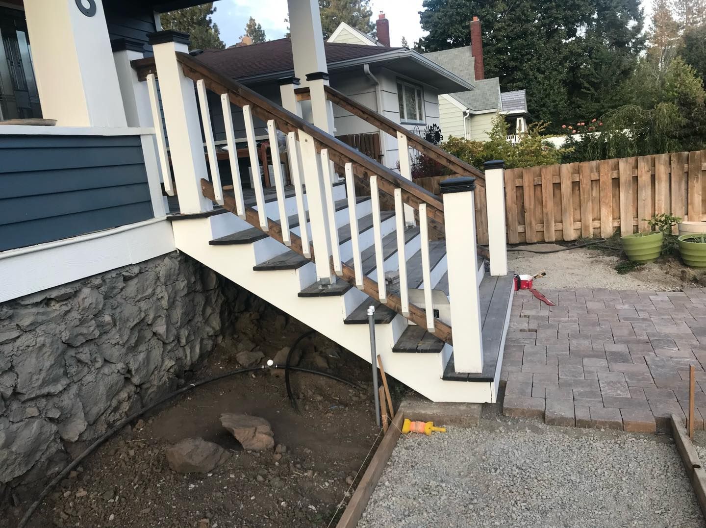 A set of stairs leading up to a house with a wooden railing.