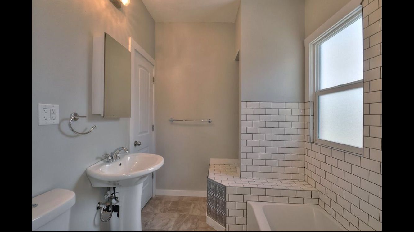 A bathroom with a sink , toilet , and bathtub.