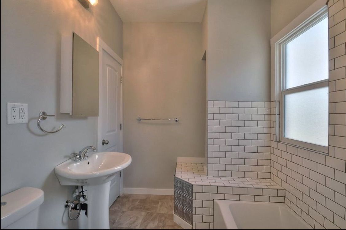 A bathroom with a sink , toilet , and bathtub