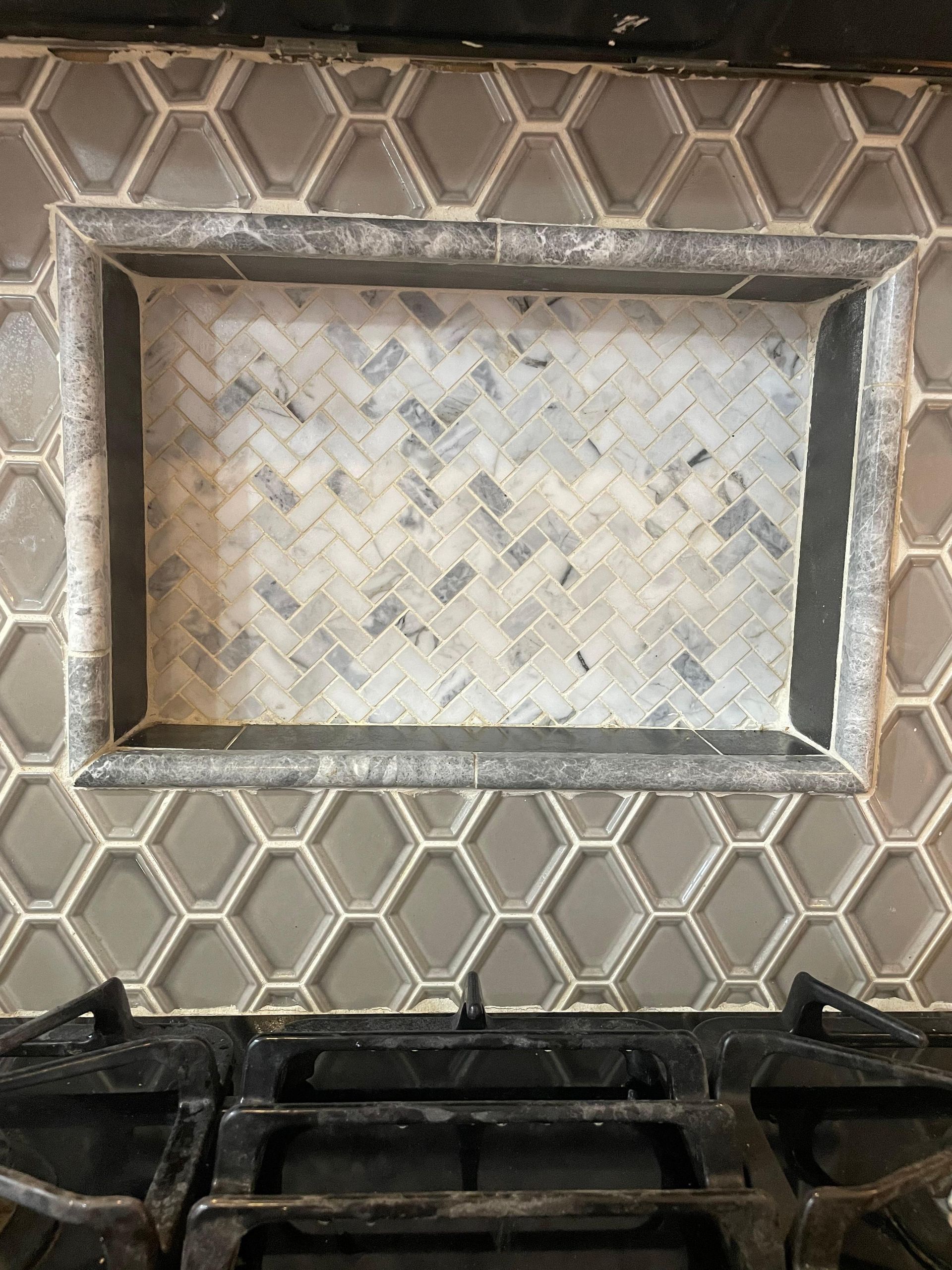 A tray is sitting on top of a tiled counter next to a stove.