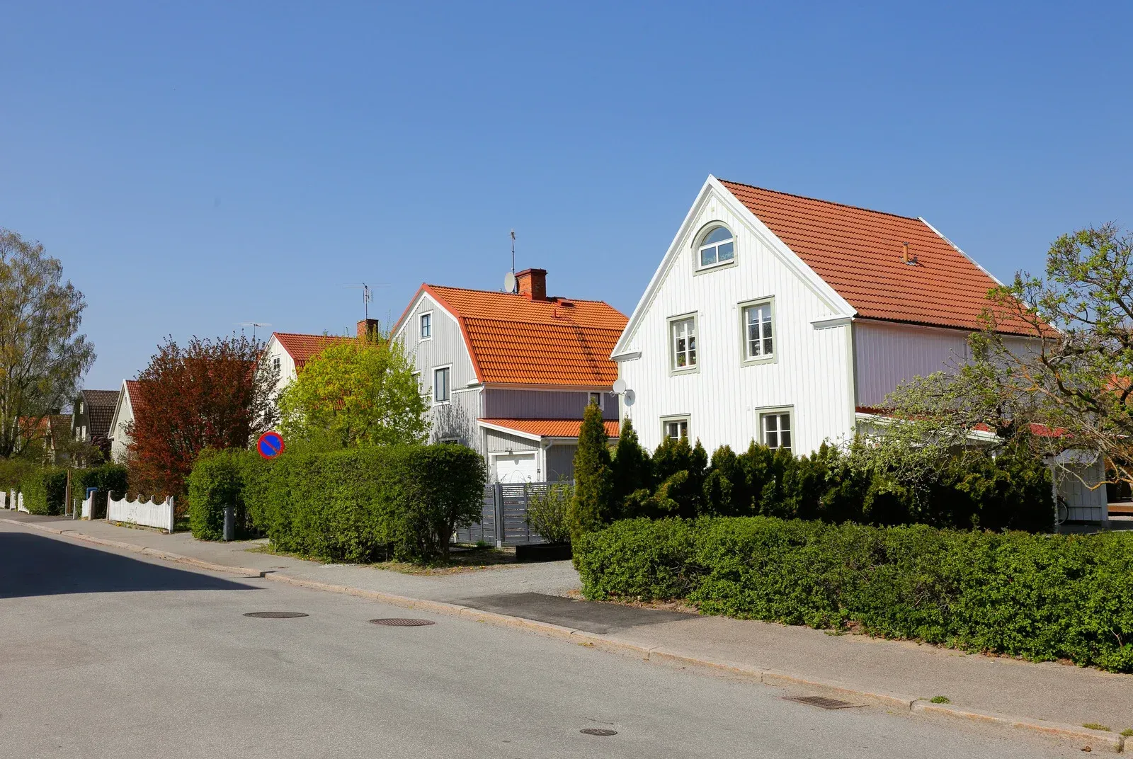 A row of white houses with red tile roofs