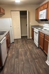 A kitchen with a refrigerator , stove , dishwasher , and microwave.