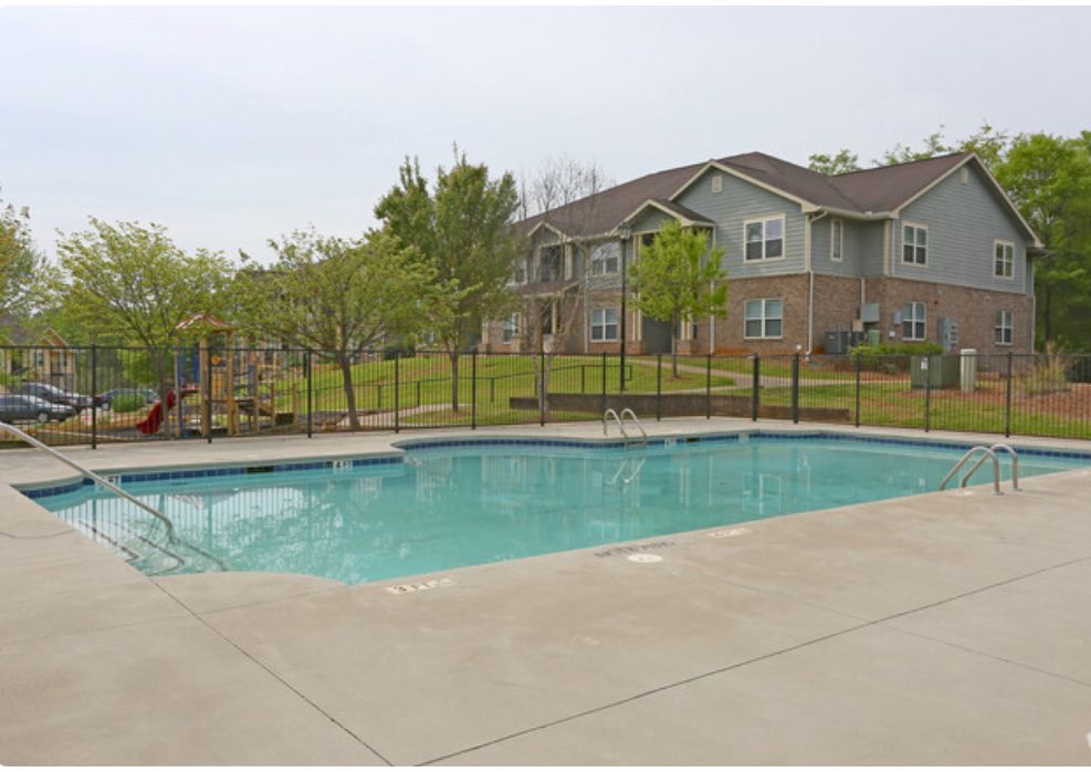 A large swimming pool in front of a house
