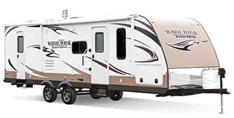 White Hawk travel trailer, white and brown exterior, two axles, extended awning, parked outside.