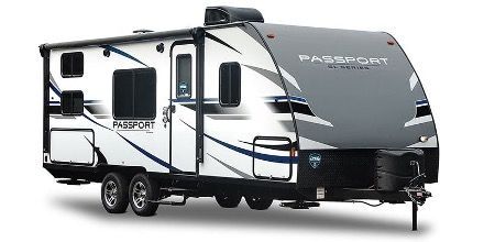 White and gray Passport travel trailer.