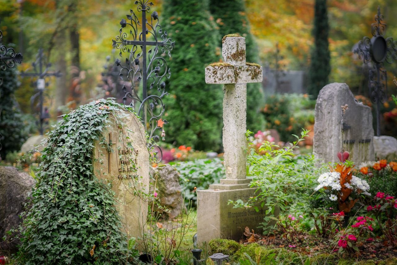 Cemetery with a lot of natural plants around, mostly green, but some colorful.