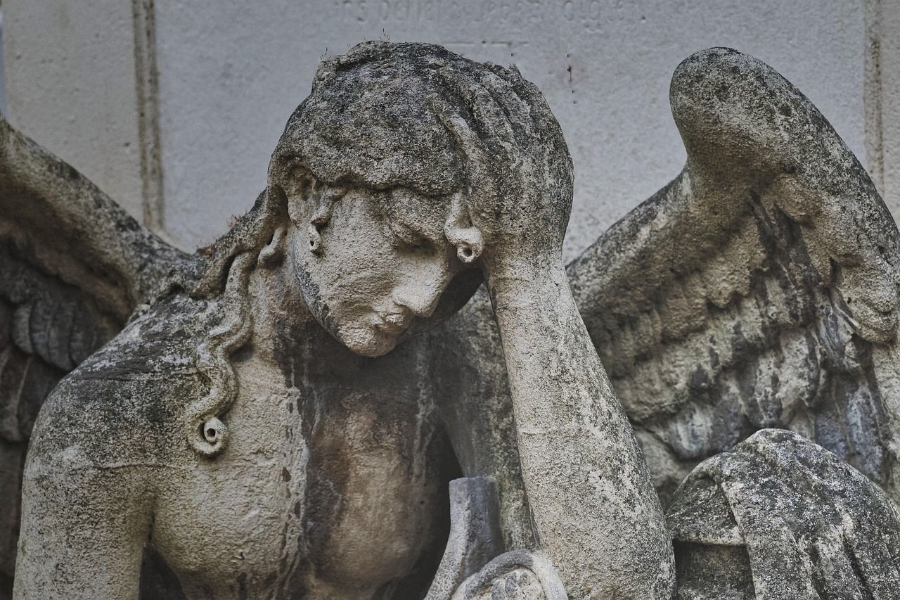 Photo of an angel statue in a pensive pose