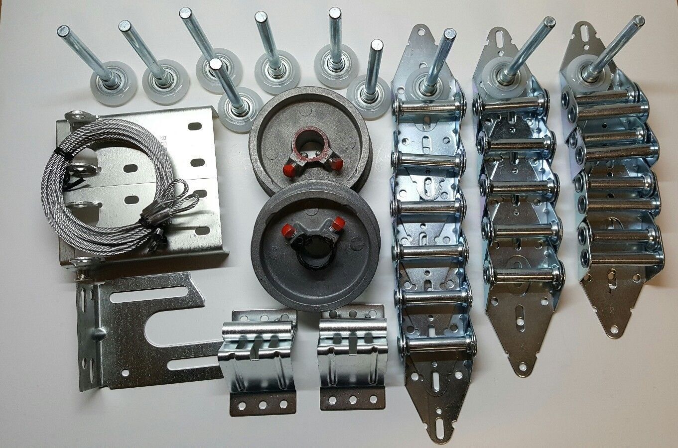 A bunch of garage door parts on a white surface