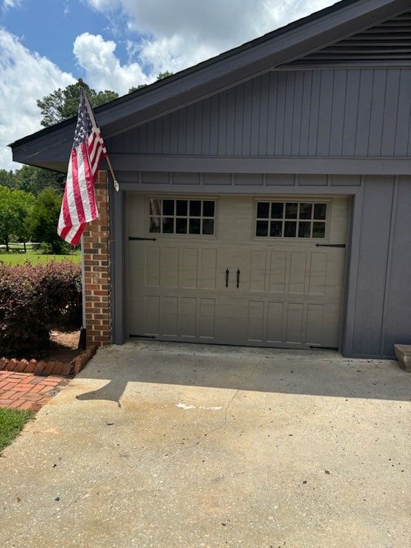 A garage door with an american flag hanging from it