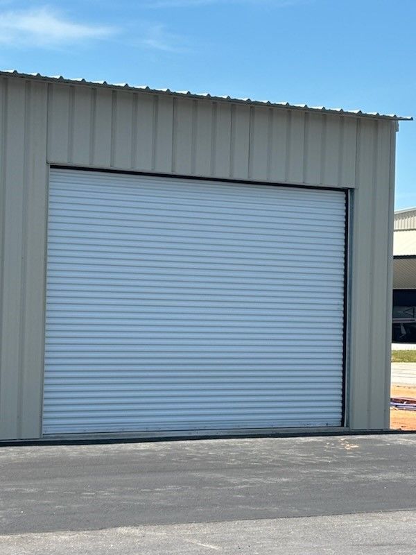 A white garage door with a blue sky in the background