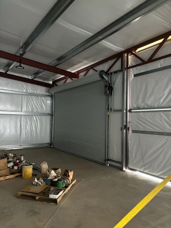 An empty garage with a yellow line on the floor