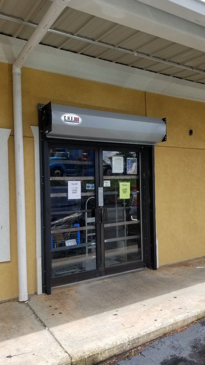 A store front with a rolling shutter on the door.