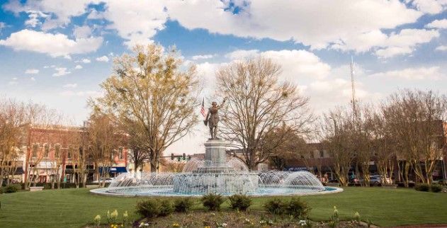 A fountain in a park with a statue in the middle of it in LaGrange Ga