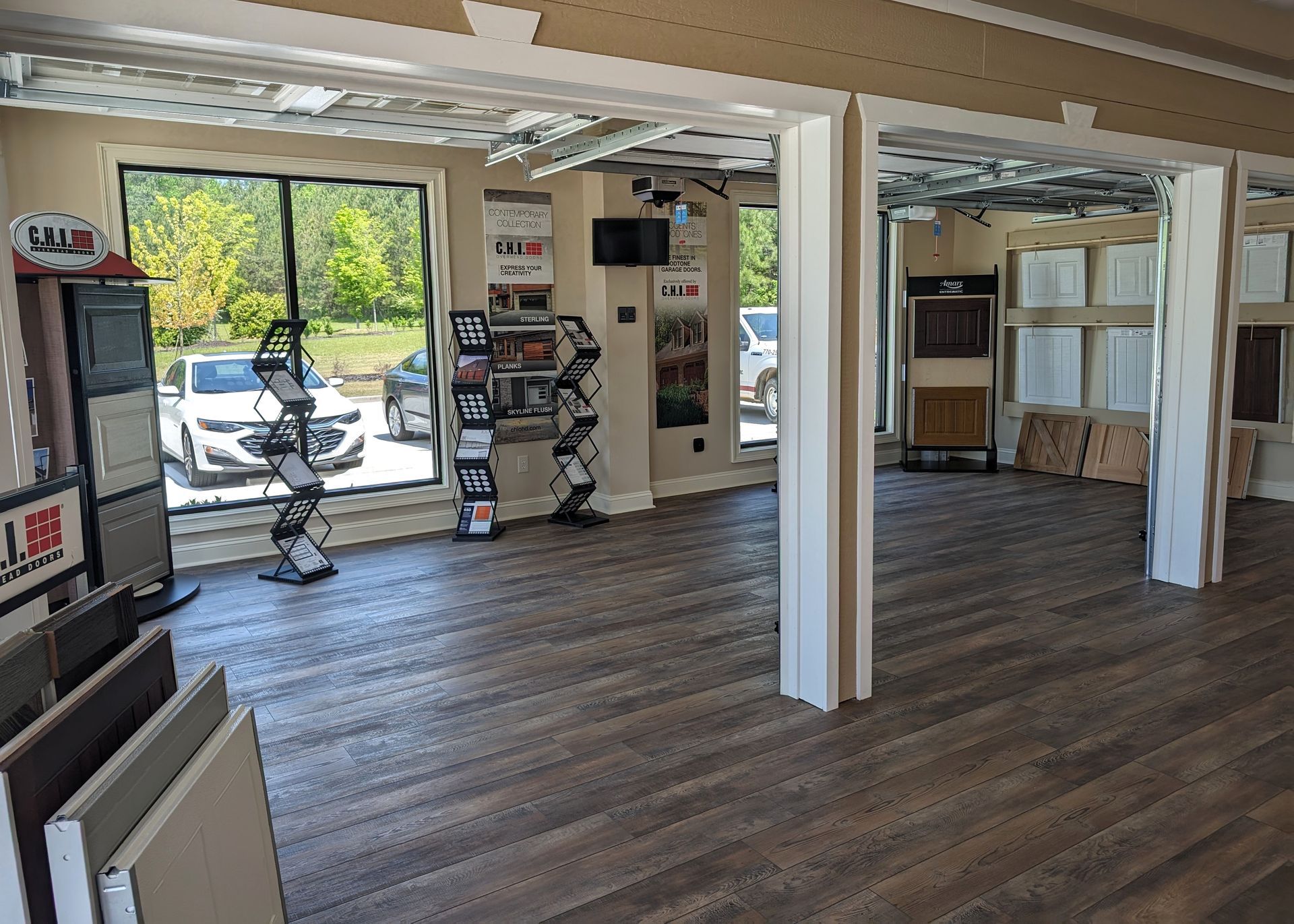 A large room with a wooden floor and a lot of windows.