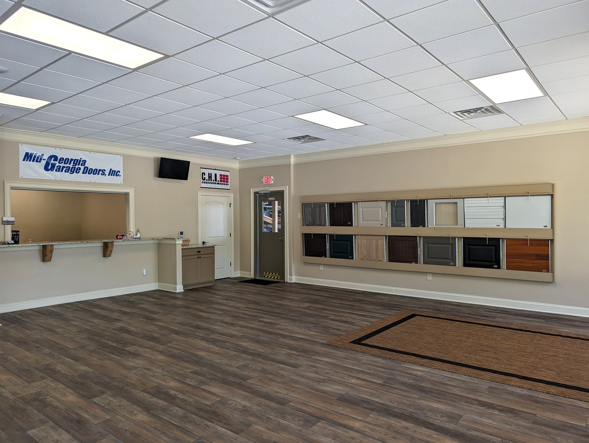 A large room with hardwood floors and a ceiling light.