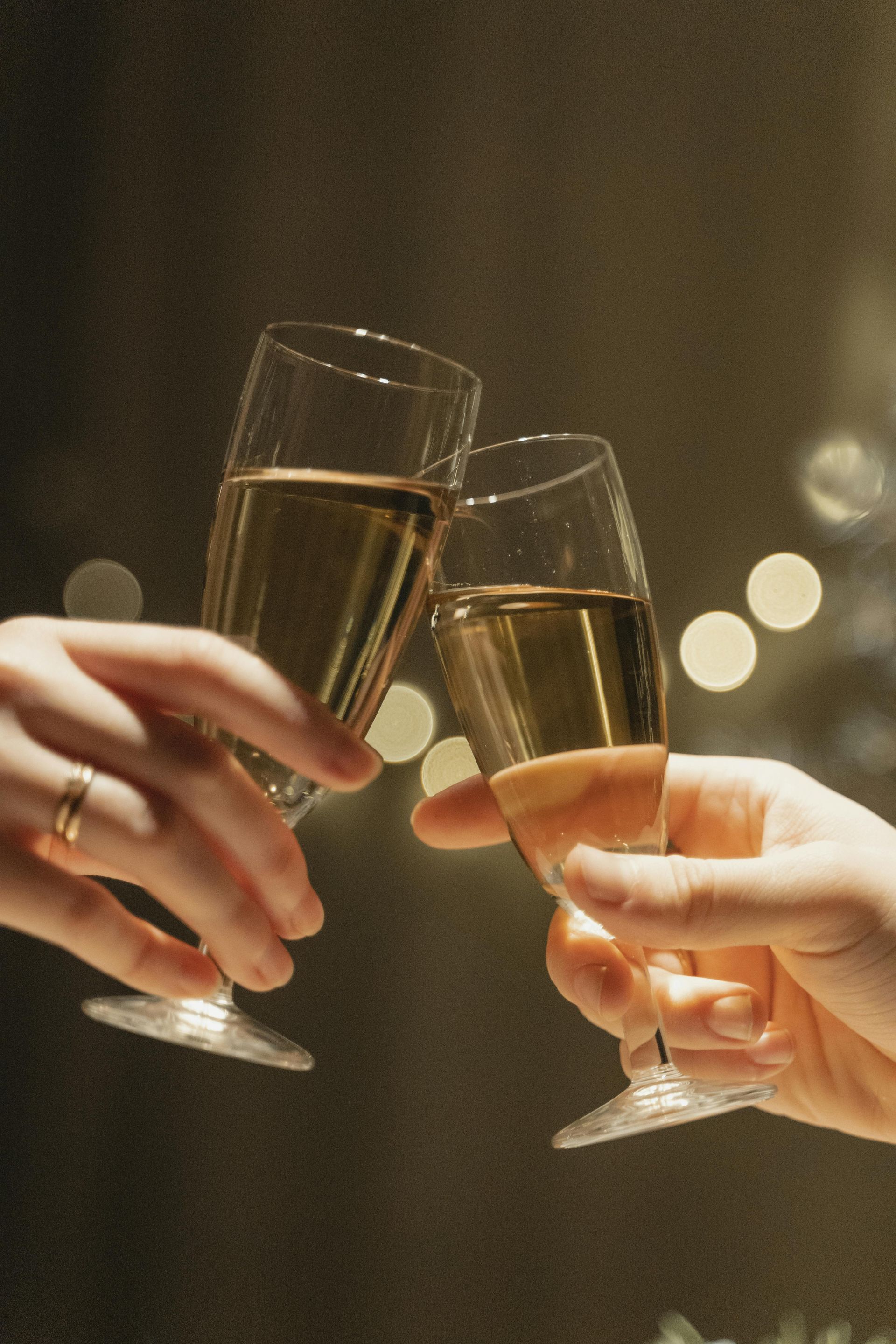 Two people are toasting with champagne glasses.