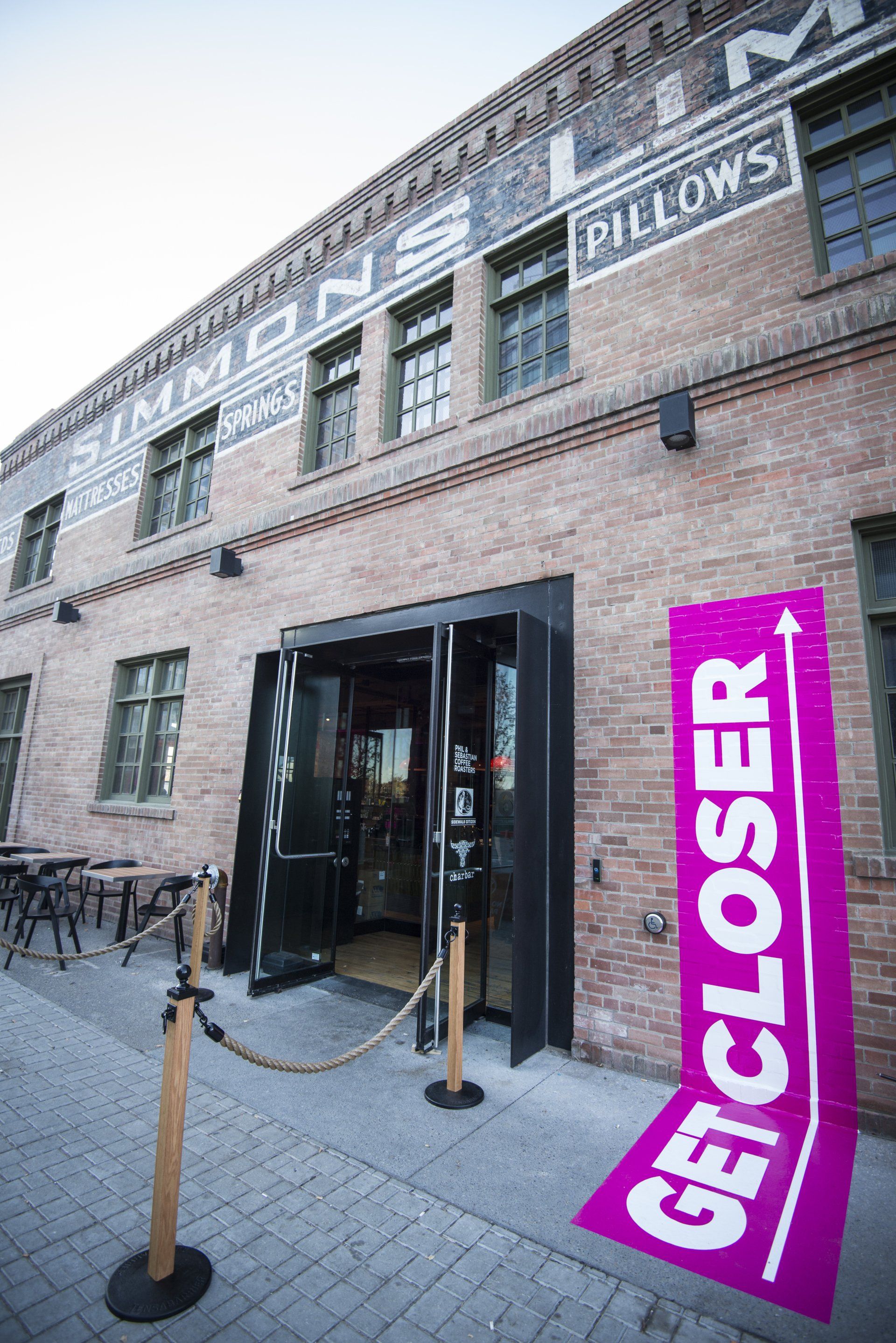 A brick building with a sign that says get closer on it.
