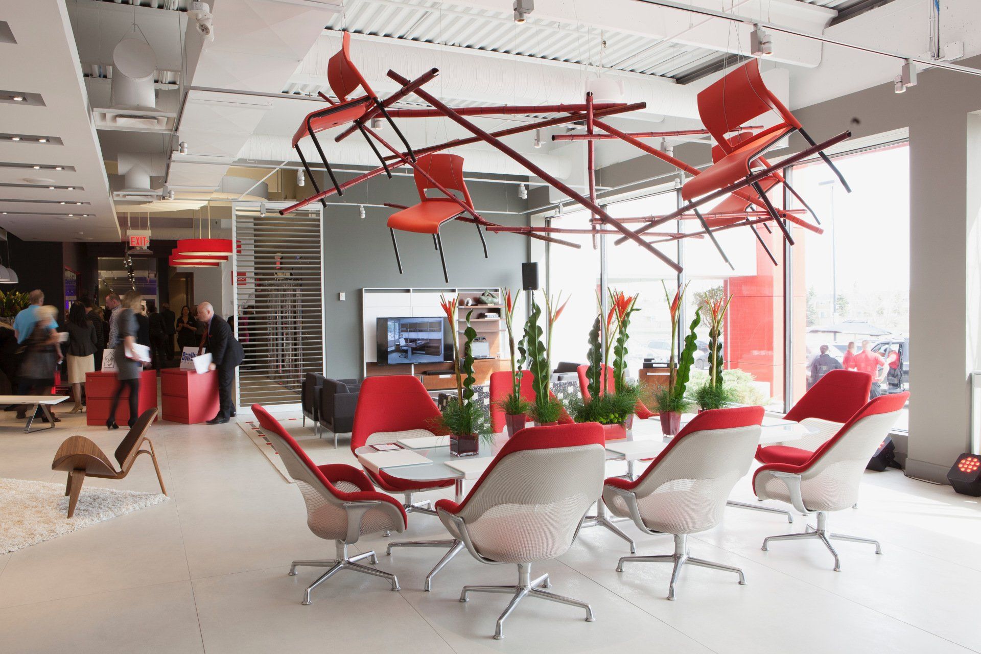 A room with red chairs hanging from the ceiling