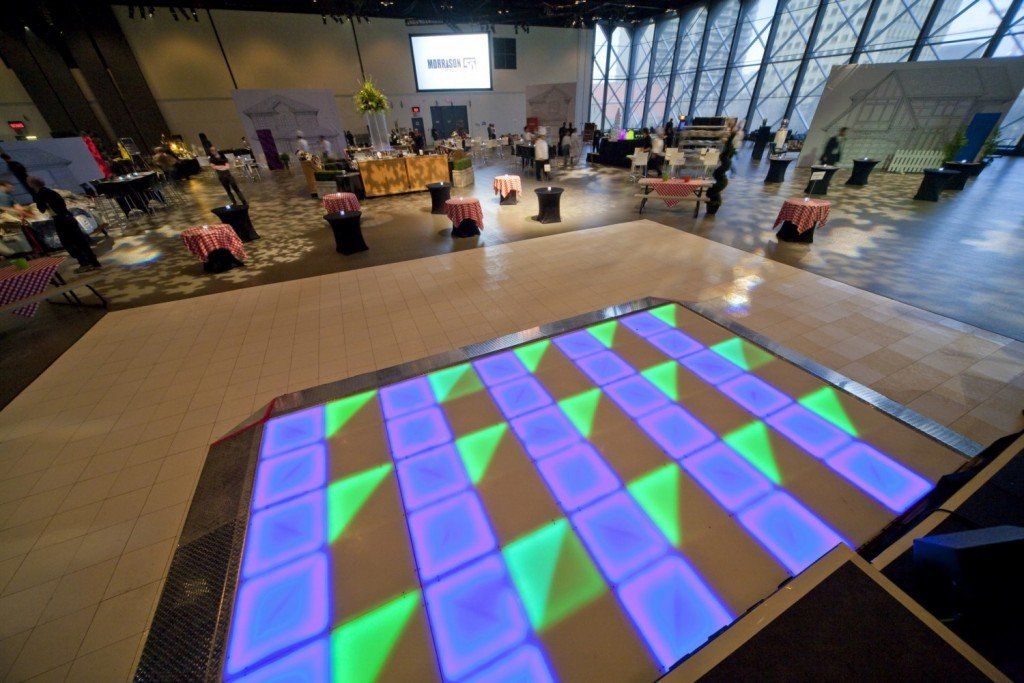 A large room with tables and chairs and a dance floor