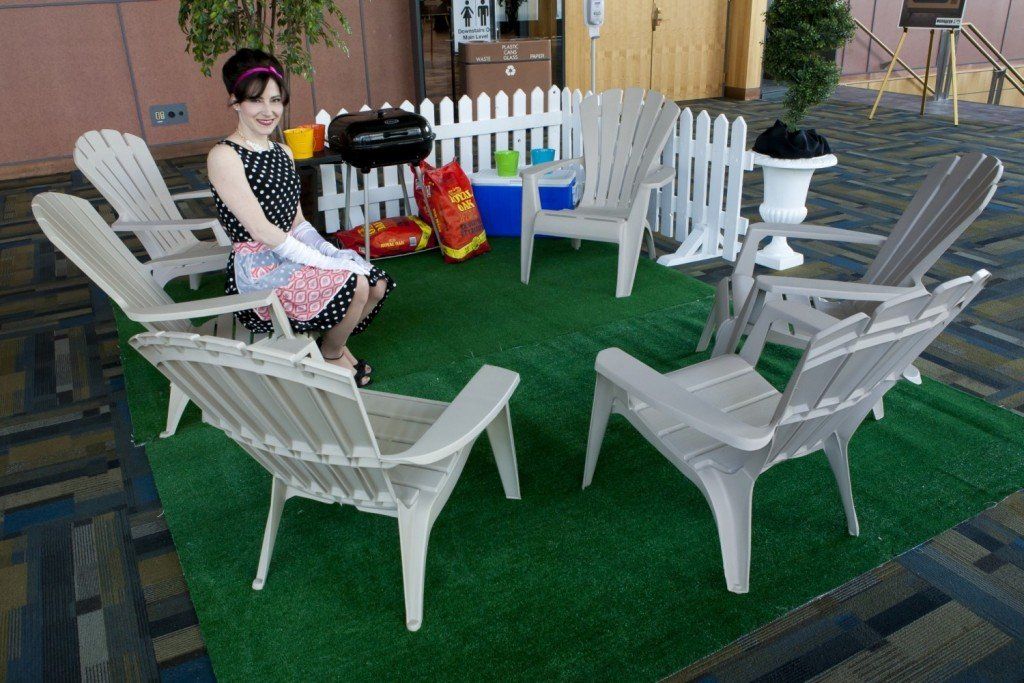 A woman is sitting in a circle of chairs