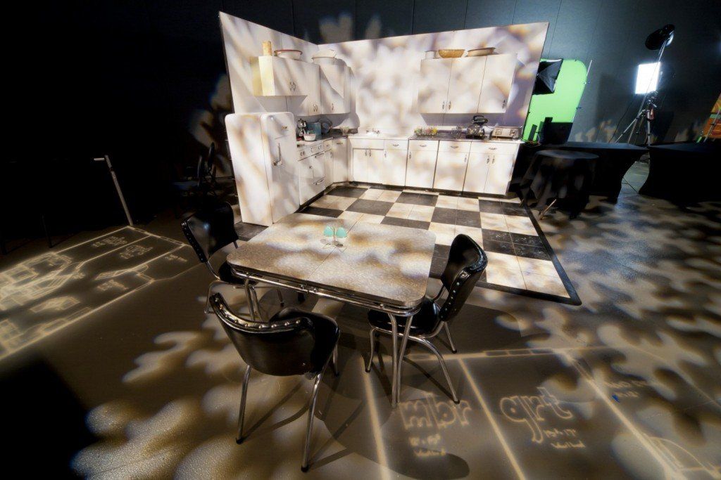 A table and chairs in a room with a checkered floor