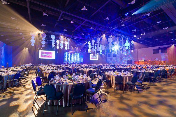 A large room with tables and chairs set up for a banquet.